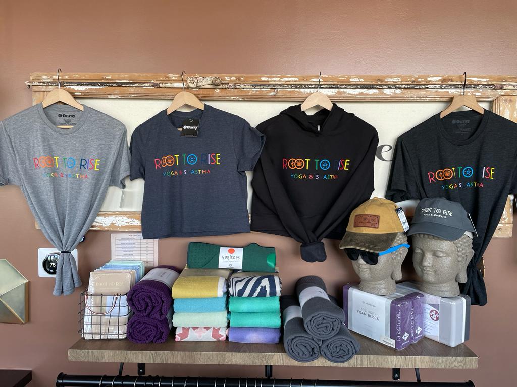 root to rise yoga Denver merchandise hung up on a wall.
