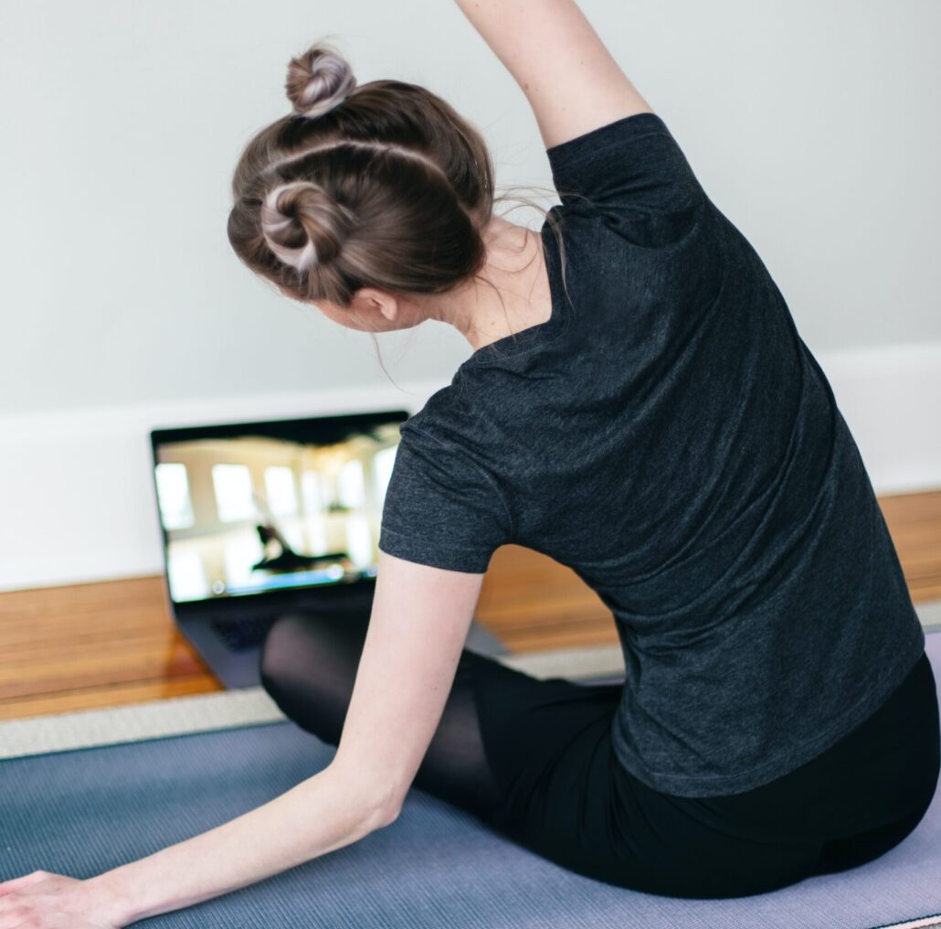 A young woman doing online yoga class